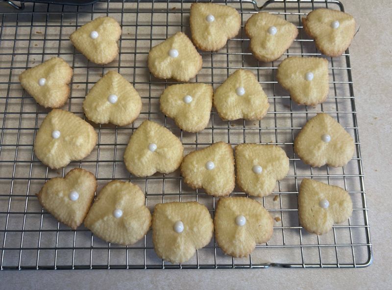 Baked almond spritz cookies on cooling rack