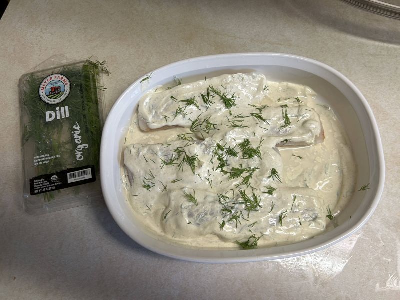 Cod added and covered with remaining sour cream mixture. Garnished with chopped dill - ready to bake at 400&deg;F for 15&ndash;18 minutes until flaky.