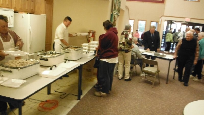 Several men working to prepare carry-out meals