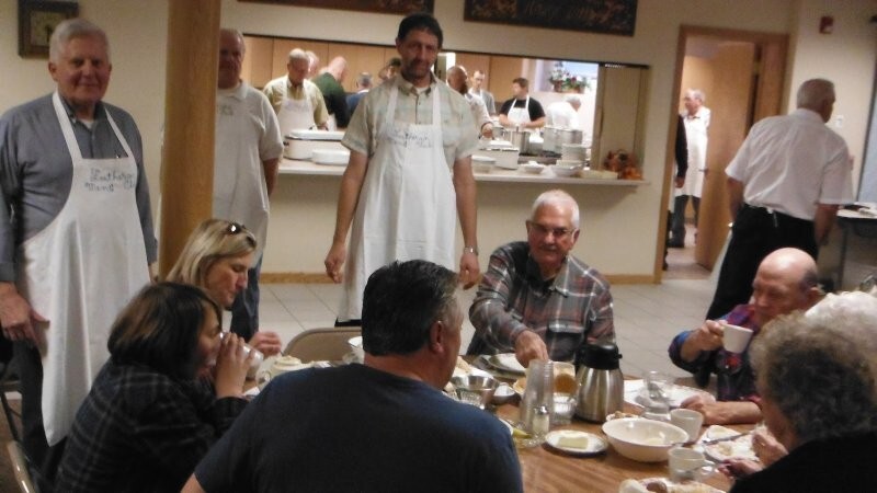 Robert Dahl, Donald Norby, and Robert Norby checking tables of diners