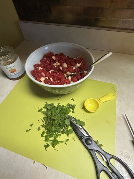 Adding chopped mint to berry fruit salsa