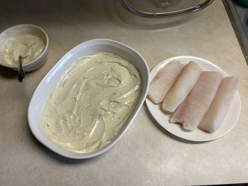Baking dish prepared with sour cream for cod bake