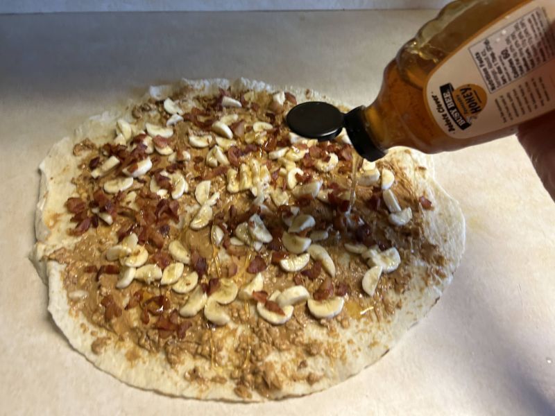 Adding crumbled bacon and drizzling honey over the banana and peanut butter lefse