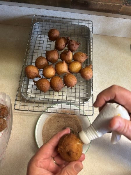 Filling donut holes with cloudberry preserves