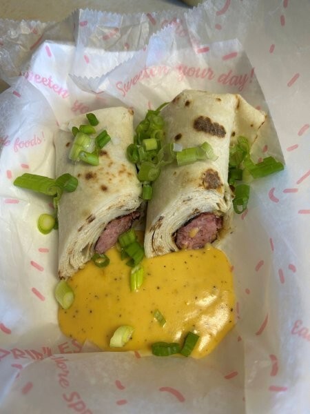 Finished lefse brats with dip and garnish