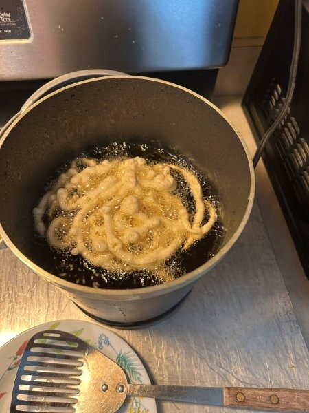 First side of funnel cake frying