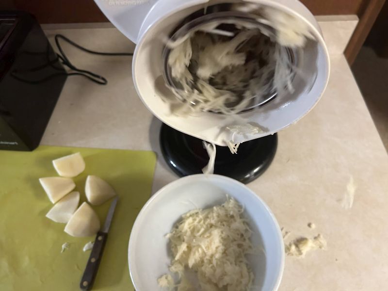 Grating russet potatoes for Klubb, a traditional Norwegian potato dumpling