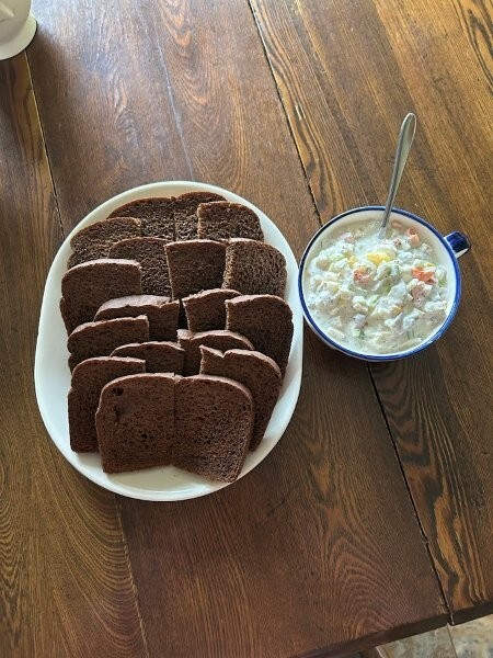 Herring salad with rye bread closeup.