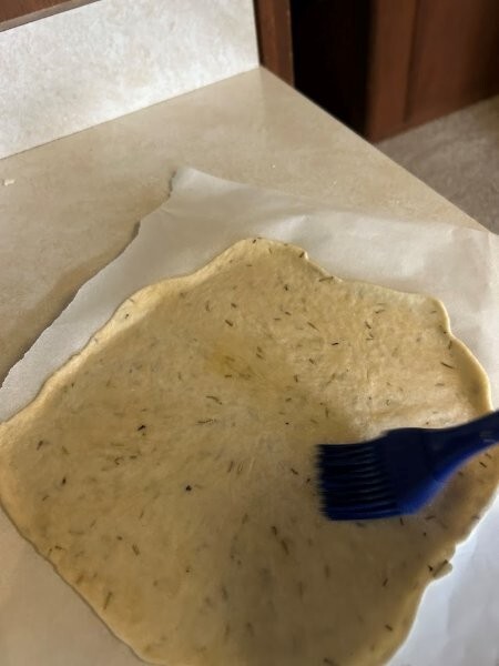 Flatbread rolled thin with a brushi of olive oil before adding more rosemary and sea salt.