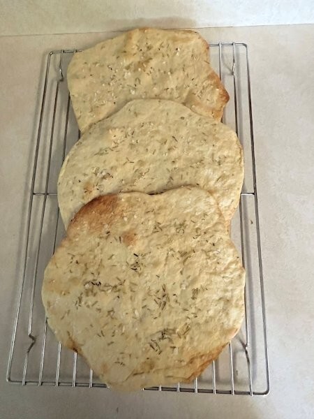 The flatbread is all baked and ready to be broken for serving.