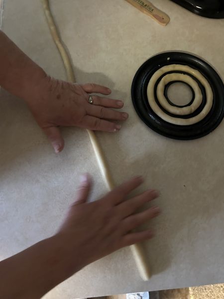 Rolling kransekake dough into half-inch ropes