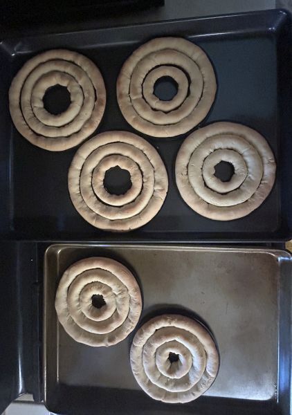 Baked kransekake rings cooling on rack