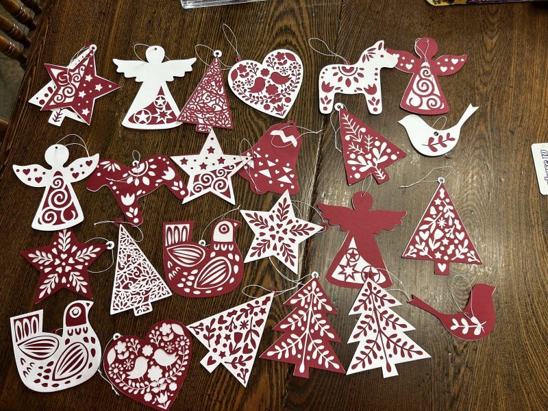 Layered Norwegian paper ornaments finished, threaded, and ready to hang on the Christmas tree.