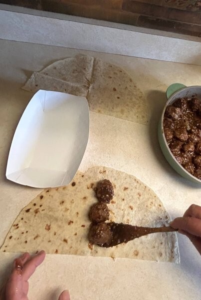 Three meatballs centered on a half piece of lefse