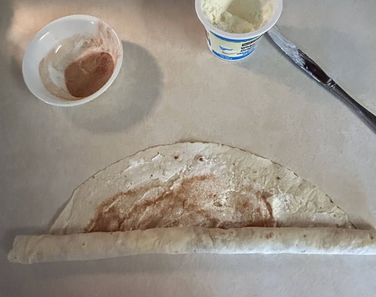 Rolling up the lefse into a cylinder for pinwheels