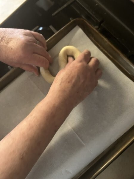 Form the cookie in the shape of a letter “S” on the parchment paper covered baking sheet. When all cookies are formed, brush the tops with remaining egg wash and sprinkle generously with either large crystal sugar or Swedish Pearl Sugar.