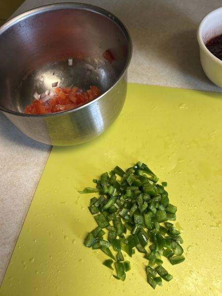 Diced jalapeño added to salsa with cilantro and salt
