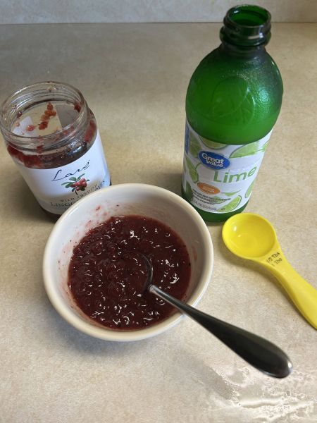 Mixing lingonberry preserves and lime juice