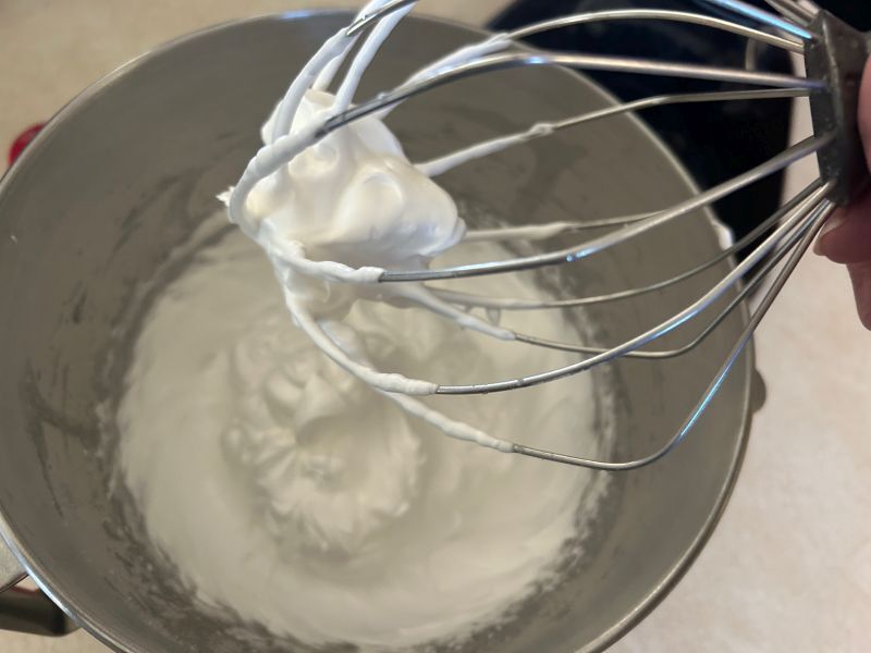 Meringue whipped to stiff peaks, ready to spread on sour cream raisin pie