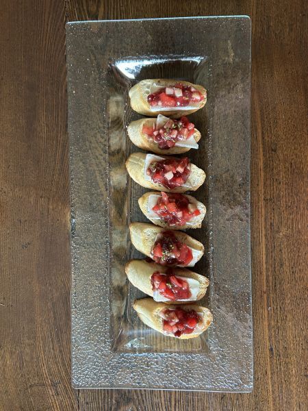 Assembled bruschetta with lingonberry salsa and Brie