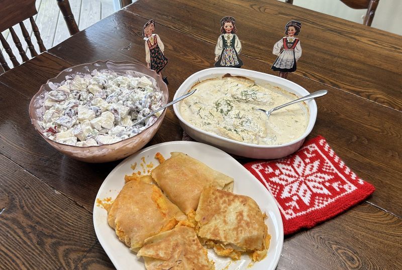 Complete Norwegian-style January dinner featuring cod, Waldorf salad, vegetable lefse wrap, and Riskrem