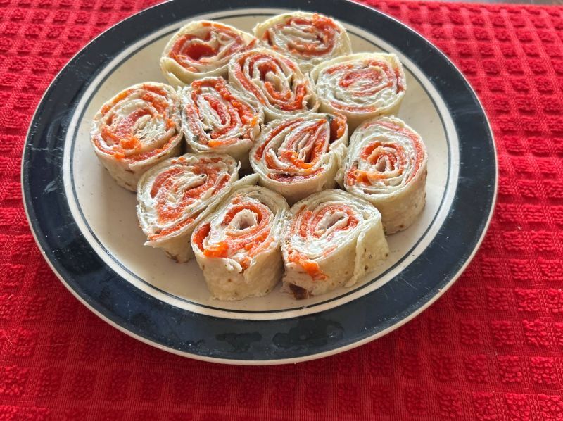 Finished Norwegian lefse pinwheels with smoked salmon and cream cheese, served as holiday appetizers