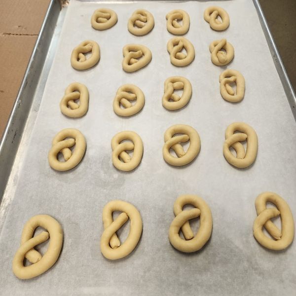 Pretzel-shaped Norwegian kringla cookies ready to bake at Norsland Lefse