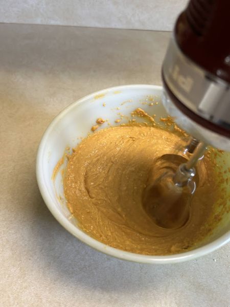 Mixing pumpkin lefse roll filling in a bowl.