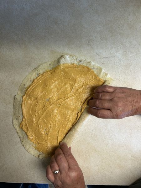 Rolled lefse with pumpkin filling inside.