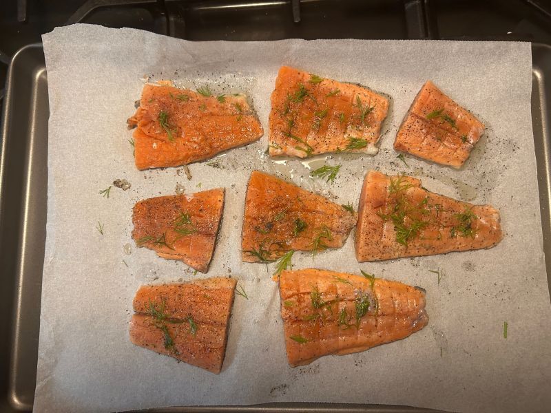 Raw salmon fillet on a baking sheet prepared for wrapping in lefse
