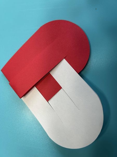 Beginning to weave the first strip of a Scandinavian paper heart basket.