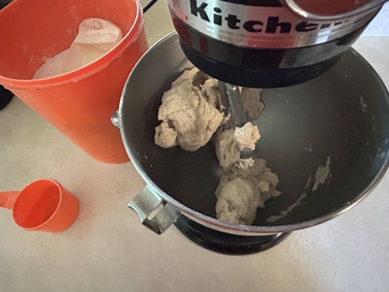 Bread flour added to Skolebrod dough, pulling from bowl