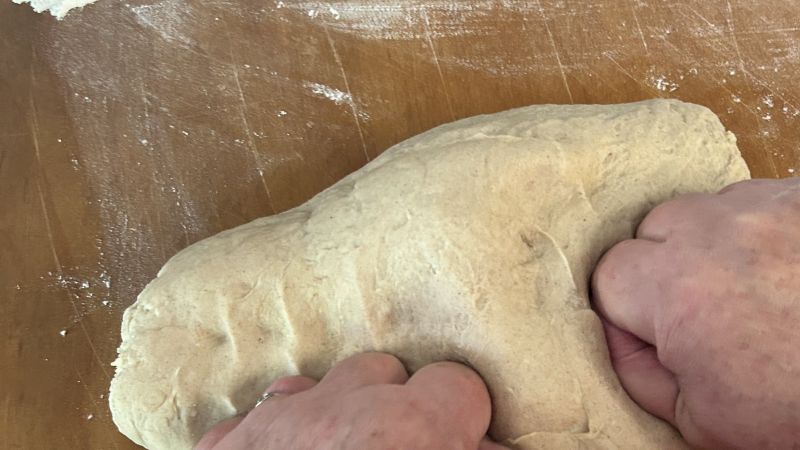 Kneading Skolebrod dough until smooth and shiny