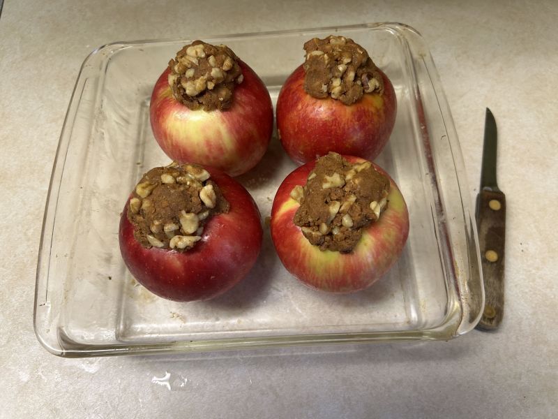 Baking dish of apples filled with Gjetost mixture ready for oven