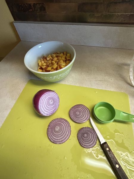 Chopped peaches and red onion for peach salsa
