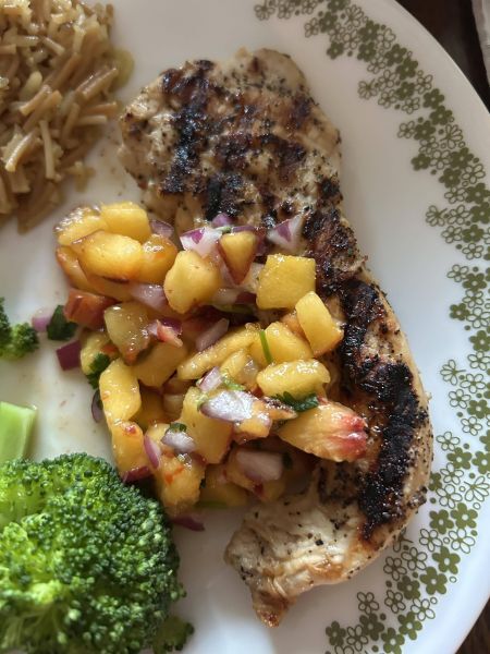Close-up of peach salsa and grilled chicken