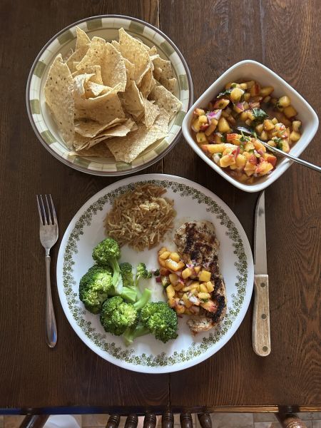 Peach salsa served with grilled chicken, broccoli and rice
