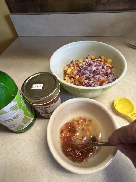 Mixing hot pepper jelly and lime juice for salsa