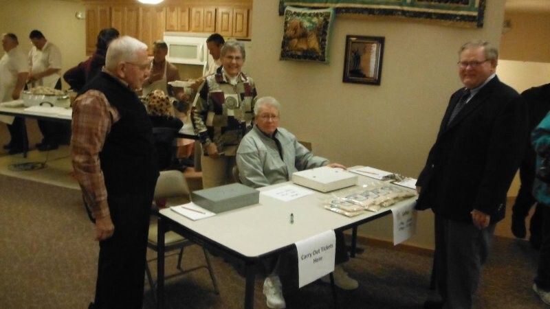 Robert Boyum and Mary taking tickets; Glenn Woxland checks in