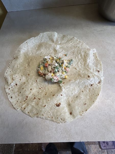 Pot pie filling added to the center of a lefse round.