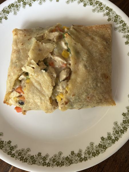 Turkey pot pie lefse pocket cut open showing filling inside.