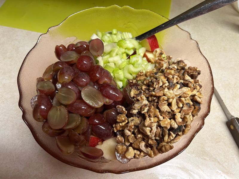 Apples, celery, grapes, and walnuts combined for Waldorf salad